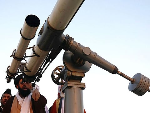 Members of the moon sighting committee use telescope to see the new moon that will mark the start of the holy month of Ramadan, from Pakistan's Meteorological Department (PMD) building in Karachi, Pakistan May 5, 2019.