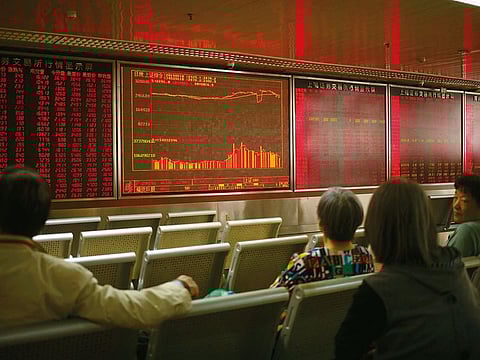 Chinese investors monitor stock prices at a brokerage house in Beijing.