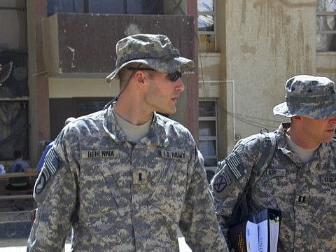 In this Sunday, Sept. 21, 2008, file photo, 1st Lt. Michael C. Behenna, left, and his defense attorney Capt. Tom Clark, right, walk in Camp Speicher, a large U.S. base near Tikrit, north of Baghdad, Iraq.