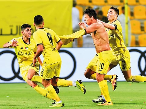 Al Wasl’s Brazilian mid-fielder Fabio De Lima celebrates with teammates after scoring the match-winner against Sharjah late in injury time on Saturday.