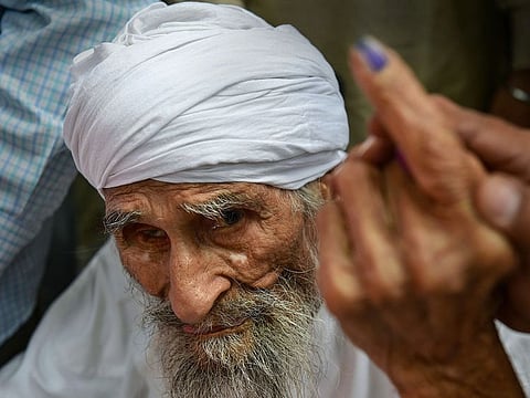 Bachan Singh ,111, the oldest voter in Delhi, leaves the polling booth after casting his vote for the sixth phase of the 2019 Lok Sabha elections, west Delhi, Sunday, May 12, 2019.