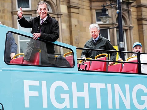 Brexit Party leader Nigel Farage rides a campaign bus in Sunderland, Britain, on Saturday. The deadline to leave the European Union has been extended to October 31.