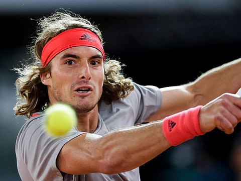 Stefanos Tsitsipas of Greece returns the ball to Rafael Nadal of Spain during the Madrid Open tennis men's semi-final match in Madrid, Spain, Saturday, May 11, 2019.