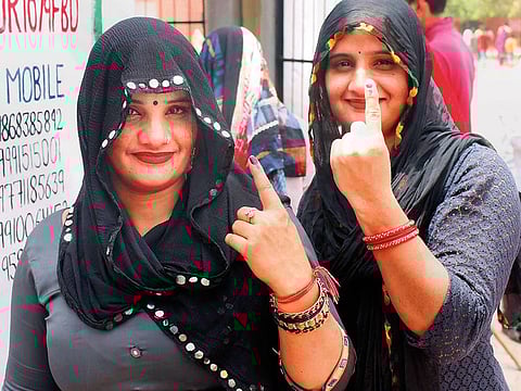 Voters show their fingers marked with indelible ink outside a polling station during the sixth phase of Lok Sabha polls, in Faridabad, on Sunday, May 12, 2019.