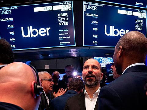 Uber CEO Dara Khosrowshahi talks to traders after the opening bell during his ride sharing companie's IPO at the New York Stock Exchange (NYSE) on May 10, 2019 on Wall Street.
