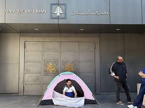 A retired soldier sits in a tent as he takes part in a protest against draft state budget proposals in Beirut.
