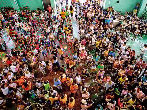 People wait for their turn to vote at Baseco Elementary School in Manila yesterday. Filipinos voted in an election that is expected to strengthen President Duterte’s grip on power.