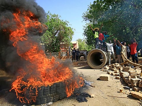 Sudanese protesters burn tyres as they block Nile Street for the second consecutive day during continuing protests in Sudan's capital Khartoum on May 13, 2019.
