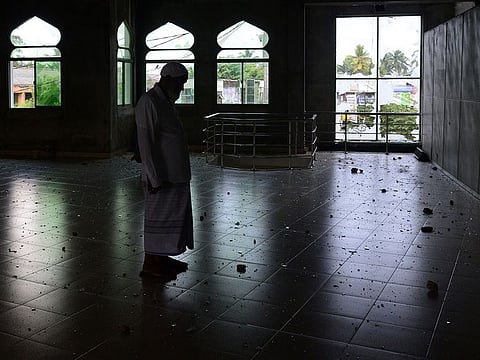 A Muslim man stands inside the Jumha mosque after a mob attack in Minuwangoda on May 14, 2019. A Sri Lankan province north of the capital was under indefinite curfew after the first death in anti-Muslim riots in the wake of the Easter terror attacks, police said.
