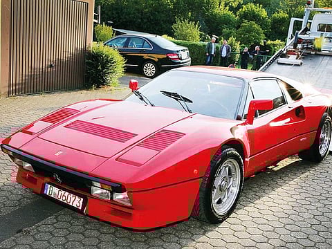A Ferrari 288 GTO vintage car is being pulled on a tow truck on Wednesday in Grevenbroich, western Germany, after the stolen vehicle was discovered in a garage.