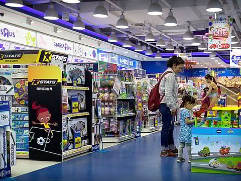Customers shop at a toy store in Beijing.