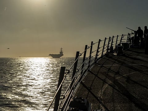 In a photo from the U.S. Navy, the guided-missile destroyer Bainbridge follows the aircraft carrier Abraham Lincoln into the Strait of Gibraltar.