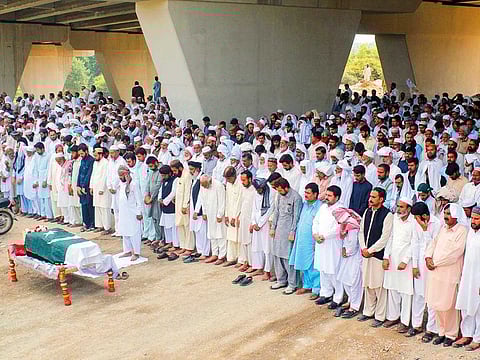 Residents offer prayers at the funeral for a private security officer who was killed in the deadly attack by gunmen who stormed the Pearl Continental hotel in Gwadar, Balochistan.
