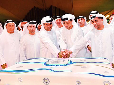 Shaikh Mansour Bin Zayed Al Nahyan, Deputy Prime Minister and Minister of Presidential Affairs, cutting a cake to celebrate Manchester City’s successful defence of the Premier League title. City edged out Liverpool by one point to retain the crown.