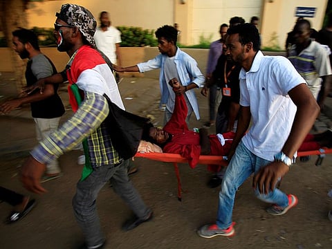 Civilians evacuate a Sudanese protester injured during demonstrations along a street in central Khartoum, Sudan May 15, 2019.
