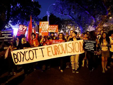 Protesters hold banners and placards as they take part in a demonstration calling for an end to Israel's policy towards Gaza and a boycott of the 2019 Eurovision Song Contest as the first semi final of the contest begins in Tel Aviv