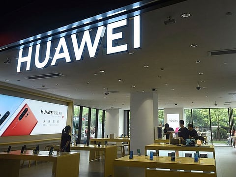 Shoppers browse smartphones at a Huawei retail store in Hangzhou in eastern China's Zhejiang province.