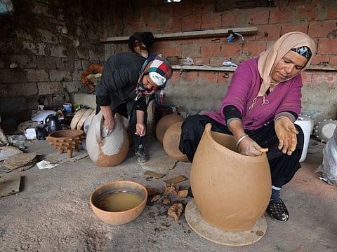 Sabiha Ayari (L), a Tunisian potter in her fifties, works with her sister-in-law in the village of Sejnane.
