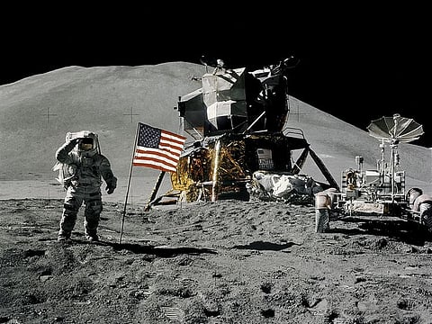 Astronaut James Irwin, lunar module pilot, gives a military salute while standing beside the U.S. flag during Apollo 15 lunar surface extravehicular activity (EVA) at the Hadley-Apennine landing site on the moon, August 1, 1971.