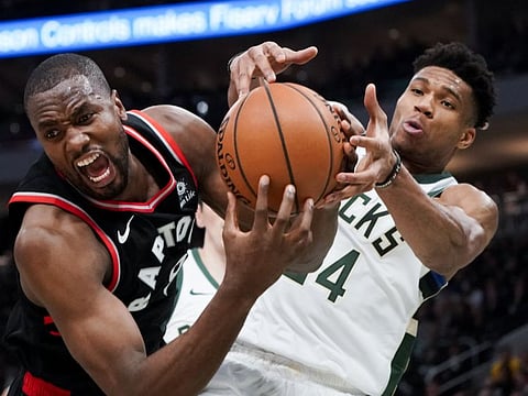 Milwaukee Bucks' Giannis Antetokounmpo tries to steal the ball from Toronto Raptors' Serge Ibaka during the second half of Game 2 of the NBA Eastern Conference basketball playoff finals Friday, May 17, 2019, in Milwaukee.