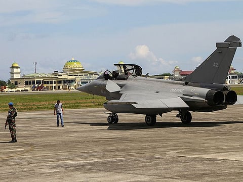 Indonesian military personnel stand guard near one of seven French Navy Rafale jet fighters parked on the tarmac at Sultan Iskandar Muda Air Base in Aceh Besar, Indonesia, Sunday, May 19, 2019.
