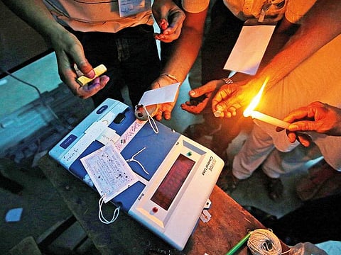 In this file picture, election officials seal an Electronic Voting Machine (EVM) at a polling station in India.