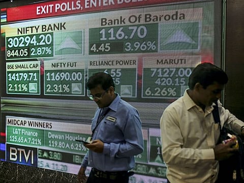 A screen displays stock figures inside the Bombay Stock Exchange (BSE) building in Mumbai, India.
