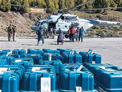 EVM machines being airlifted by Indian Air Force helicopters from a helipad at Stingri, in Lahaul district, on Monday.