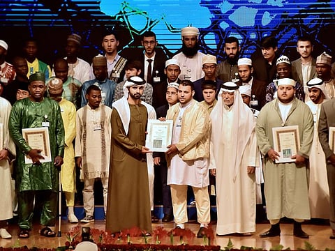 Shaikh Mansour Bin Mohammad Bin Rashid Al Maktoum presents the top prize to Muaz Mohammad from Libya.