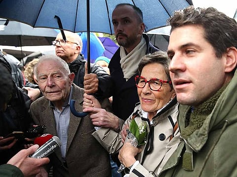 Parents and relatives of French quadriplegic Vincent Lambert, his father Pierre Lambert (L), her mother Viviane Lambert (2R) and his half-brother David Philippon (holding the umbrella) speak to the press as they arrive with members of his support committee in the Sebastopol hospital in Reims, eastern France, on May 19, 2019.