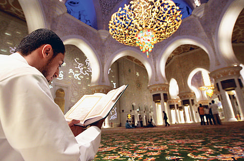 A man reads the Holy Quran at the Shaikh Zayed Mosque in Abu Dhabi.