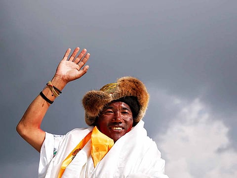 Kami Rita Sherpa waves towards the media personnel upon his arrival after climbing Mount Everest for a 22nd time, creating a new record for the most summits of the worldÕs highest mountain, in Kathmandu, Nepal May 20, 2018