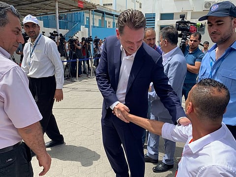 Pierre Krahenbuhl, Commissioner-General of the United Nations Relief and Works Agency (UNRWA), shakes hands with a Palestinian man after holding a news conference in Gaza City May 23, 2019.