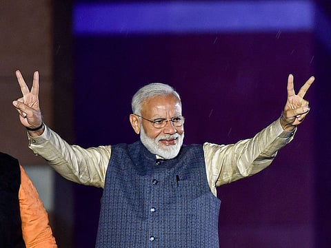 Prime Minister Narendra Modi flashes the victory sign as he arrives at the party headquarters to celebrate the party's victory in the 2019 Lok Sabha elections, in New Delhi.