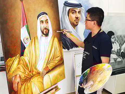 Jack Lee, the Abu Dhabi-based Chinese artist, with his paintings of late Shaikh Zayed and other UAE leaders. Lee said art was an essential and powerful tool for cultural enlightenment.