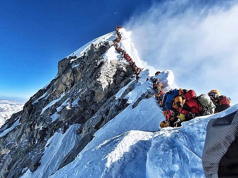 In this file handout photo taken on May 22, 2019 and released by climber Nirmal Purja's Project Possible expedition shows heavy traffic of mountain climbers lining up to stand at the summit of Mount Everest.