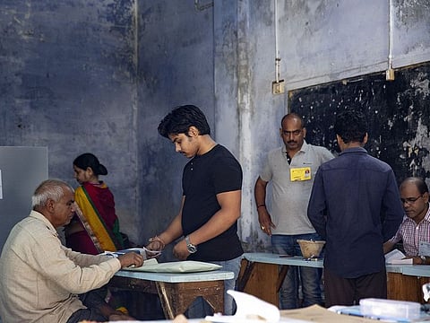 Voters register at a polling station during the seventh and final phase phase of voting for national elections in Varanasi, Uttar Pradesh, India, on Sunday, May 19, 2019.