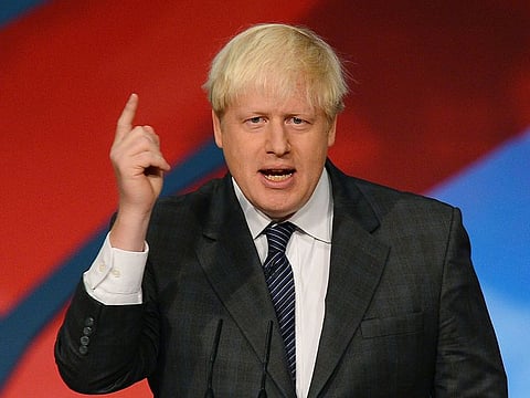 In this file photo taken on July 30, 2010 Mayor of London, Boris Johnson, rides a bicycle during the launch of the London Cycle Hire bicycle scheme in central London, on July 30, 2010.