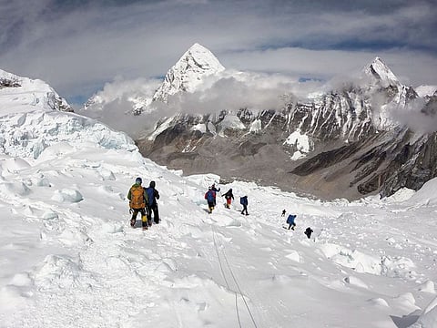 Mountaineers walk near camp one of Mount Everest, as they prepare to ascend on the south face from Nepal.