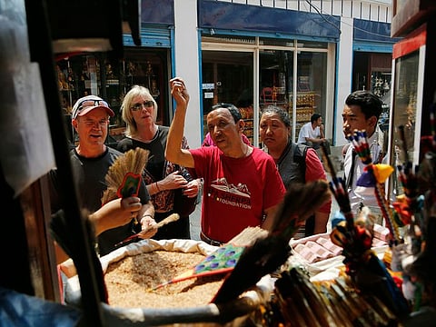 In this May 9, 2019 photo, Apa Sherpa, center, with members of his foundation walk around Boudhanath Stupa in Kathmandu, Nepal.