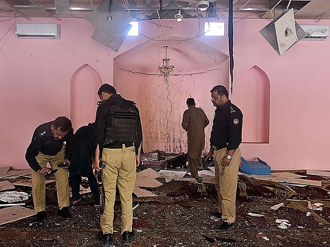 Pakistani police officials examine the interior of a mosque after a blast on the outskirts of Quetta on May 24, 2019.
