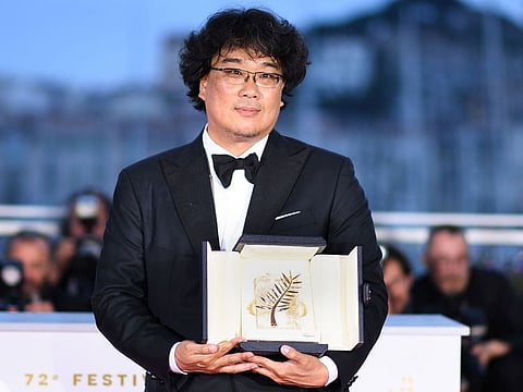 South Korean director Bong Joon-Ho poses during a photocall with his trophy after he won the Palme d'Or for the film "Parasite (Gisaengchung)" on May 25, 2019 during the closing ceremony of the 72nd edition of the Cannes Film Festival in Cannes, southern France.