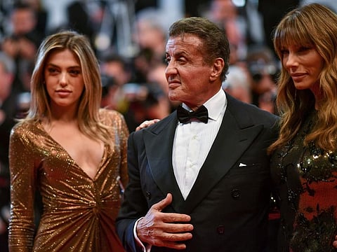US actor Sylvester Stallone (centre) arrives with his wife Jennifer Flavin (right) and their daughter Sistine Rose for the screening of "Homage to Sylvester Stallone - Rambo : First Blood" at the 72nd edition of the Cannes Film Festival in Cannes, southern France, on May 24, 2019.