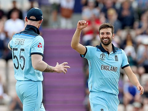 England's Mark Wood celebrates with Ben Stokes after taking the wicket of Australia's Aaron Finch.