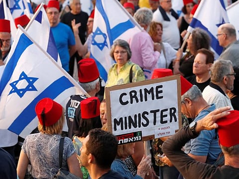 Israeli oposition parties' supporters hold flags and banners as they attend a rally against Prime Minister Benjamin Netanyahu on May 25, 2019 in the coastal city of Tel Aviv.
