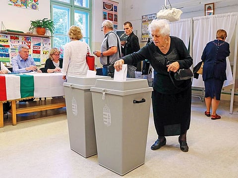 A voter casts her ballot for the European elections at a polling station in Budapest.