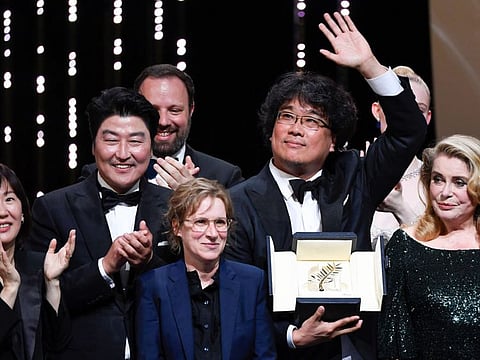 South Korean director Bong Joon-Ho (2ndR) poses on stage with (From2ndL) South Korean actor Song Kang-ho, Greek director and member of the jury of the Cannes Film Festival Yorgos Lanthimos (Rear), US director and member of the jury of the Cannes Film Festival Kelly Reichardt and French actress Catherine Deneuve after he was awarded with the Palme d'Or for the film "Parasite" (Gisaengchung) on May 25, 2019 during the closing ceremony of the 72nd edition of the Cannes Film Festival in Cannes, southern France.