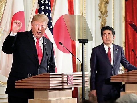 Donald Trump speaks as Shinzo Abe listens during a news conference at Akasaka Palace in Tokyo on Monday.