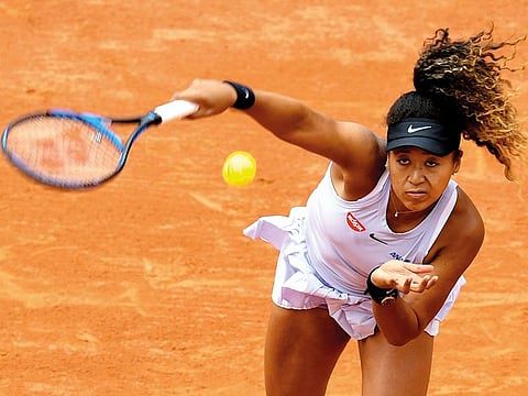 Japan's Naomi Osaka serves the ball to Slovakia's Anna Karolina Schmiedlova during their women's singles first round match on day three of The Roland Garros 2019 French Open tennis tournament in Paris on May 28, 2019.
