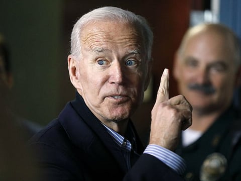 Former vice president and Democratic presidential candidate Joe Biden interacts with a supporter during a campaign stop at the Community Oven restaurant in Hampton, N.H., Monday, May 13, 2019.